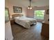 Bedroom with a ceiling fan, wood-like flooring, and a bright window view at 1733 Weeping Elm Cir, Port Orange, FL 32128