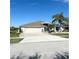 Well maintained, one-story home with a large driveway and a two-car garage at 1733 Weeping Elm Cir, Port Orange, FL 32128
