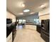 Bright kitchen featuring stainless steel appliances, white cabinetry, and skylight for natural light at 1733 Weeping Elm Cir, Port Orange, FL 32128