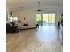 Spacious living room with wood-like flooring and a view of the screened-in patio at 1733 Weeping Elm Cir, Port Orange, FL 32128