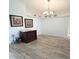 Light-filled living room with wood floors, decorative dresser and chandelier at 1733 Weeping Elm Cir, Port Orange, FL 32128