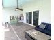 Outdoor patio with a blue sofa and grill, providing a comfortable space for leisure and relaxation at 1733 Weeping Elm Cir, Port Orange, FL 32128