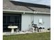 Pool equipment on the side of the house featuring solar panels on the roof at 1733 Weeping Elm Cir, Port Orange, FL 32128