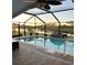 Enclosed pool area with lovely lake views, featuring a fountain, plants and brick surround at 1733 Weeping Elm Cir, Port Orange, FL 32128