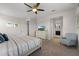 Cozy bedroom with a ceiling fan, a comfortable bed, and access to an en-suite bathroom at 1841 Sawyer Palm Pl, Kissimmee, FL 34747