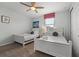 Bright bedroom with two twin beds, white furniture, a ceiling fan, and a closet at 1841 Sawyer Palm Pl, Kissimmee, FL 34747