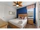 Inviting bedroom with light-colored walls, a wooden bed frame, and matching nightstands at 1841 Sawyer Palm Pl, Kissimmee, FL 34747
