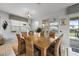 Bright dining room with a wooden table, seating for six, and sliding glass doors to the outdoor pool area at 1841 Sawyer Palm Pl, Kissimmee, FL 34747