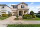 Charming home with a well-maintained lawn and inviting covered front porch at 1841 Sawyer Palm Pl, Kissimmee, FL 34747