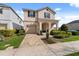 Attractive two-story home featuring a paved driveway and manicured landscaping at 1841 Sawyer Palm Pl, Kissimmee, FL 34747