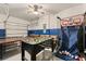 Spacious garage converted to game room with foosball, ping pong, and a basketball arcade game at 1841 Sawyer Palm Pl, Kissimmee, FL 34747