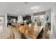 Spacious kitchen featuring dark cabinetry, stainless steel appliances, and a large wooden dining table at 1841 Sawyer Palm Pl, Kissimmee, FL 34747