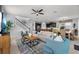 Inviting living room and kitchen area, with a staircase, and modern furnishings at 1841 Sawyer Palm Pl, Kissimmee, FL 34747