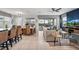 Bright, open-concept living room with tile floors, dining area, and view of the screened patio and pool at 1841 Sawyer Palm Pl, Kissimmee, FL 34747