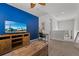 Stylish loft area with a blue accent wall, a TV, a desk, and comfortable seating at 1841 Sawyer Palm Pl, Kissimmee, FL 34747