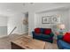 Open loft with a blue sofa, a wooden trunk, and stairs leading to the upper level at 1841 Sawyer Palm Pl, Kissimmee, FL 34747