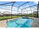 Inviting pool and spa area with well-maintained landscaping and screened enclosure at 1841 Sawyer Palm Pl, Kissimmee, FL 34747