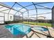 Relaxing pool and spa area, featuring brick pavers, serene privacy and a screened-in enclosure at 1841 Sawyer Palm Pl, Kissimmee, FL 34747