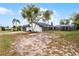 Exterior backyard view of single-story home and screened pool enclosure at 2121 Arrowhead Ave, Deltona, FL 32725