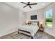 Bright bedroom features a ceiling fan, a window, and a closet for ample storage at 2121 West Pkwy, Deland, FL 32724
