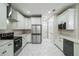 Spacious modern kitchen with white cabinets, stainless steel appliances, quartz countertops, and stylish backsplash at 2121 West Pkwy, Deland, FL 32724