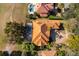 Aerial view of a luxury home featuring a terracotta tile roof, private pool, and meticulously landscaped grounds at 2313 Roat Dr, Orlando, FL 32835