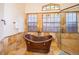 A bathroom with a copper soaking tub, walk-in shower, stone walls and floors at 2313 Roat Dr, Orlando, FL 32835