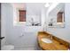 A simple bathroom with a window, toilet, mirror, sink and stone counters at 2313 Roat Dr, Orlando, FL 32835