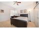 A bedroom with a bed, desk, stone floors, ceiling fan, and closet at 2313 Roat Dr, Orlando, FL 32835