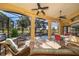 Screened in patio offers a serene view of the pool, golf course, and landscaped yard for outdoor enjoyment at 2313 Roat Dr, Orlando, FL 32835