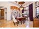 Formal dining room with large window, travertine floors, and a decorative chandelier at 2313 Roat Dr, Orlando, FL 32835
