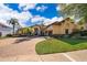Elegant exterior showcases a circular brick driveway leading to a grand two-story home with manicured landscaping at 2313 Roat Dr, Orlando, FL 32835