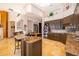 Modern kitchen featuring dark wood cabinets, granite counters, a center island, and stainless appliances at 2313 Roat Dr, Orlando, FL 32835
