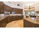 An open kitchen with custom wood cabinets, granite counters, mosaic backsplash, and modern appliances at 2313 Roat Dr, Orlando, FL 32835