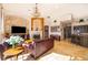 Cozy living room featuring a fireplace, chandelier, and comfortable seating at 2313 Roat Dr, Orlando, FL 32835