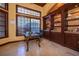 The office features dark stained built-in bookshelves and cabinets with granite countertops at 2313 Roat Dr, Orlando, FL 32835