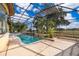 A sparkling pool and spa are surrounded by a screened enclosure with views of lush landscaping and a manicured golf course at 2313 Roat Dr, Orlando, FL 32835