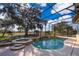 Sparkling pool and spa area, surrounded by screened enclosure, offer the perfect outdoor retreat with lush landscaping at 2313 Roat Dr, Orlando, FL 32835