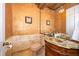 An elegant powder room with a wood vanity, copper sink, and faux painted walls at 2313 Roat Dr, Orlando, FL 32835