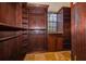 Spacious walk-in closet with custom wood shelving and a built-in dressing table with stone top at 2313 Roat Dr, Orlando, FL 32835