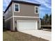 Two-story home with gray siding and a white garage door at 2455 Zuni Rd, St Cloud, FL 34771