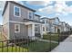 Row of new two-story homes with similar gray exteriors and fenced front yards at 2455 Zuni Rd, St Cloud, FL 34771