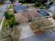 Aerial view of a home featuring a screened-in pool, two-car garage and well maintained landscaping at 290 Thomas Dr, Casselberry, FL 32707