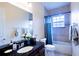 Bathroom with granite counters, stylish fixtures, and tub shower combination at 290 Thomas Dr, Casselberry, FL 32707