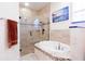 Bright and airy bathroom with tiled shower, soaking tub, and neutral color palette at 290 Thomas Dr, Casselberry, FL 32707