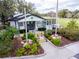 Charming clubhouse featuring well-maintained landscaping, lush plants, and welcoming entrance at 290 Thomas Dr, Casselberry, FL 32707