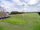 Expansive golf driving range with multiple hitting stations and manicured greens for practice at 290 Thomas Dr, Casselberry, FL 32707