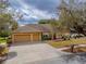 Charming single-story home with a three-car garage and a well-manicured front yard at 290 Thomas Dr, Casselberry, FL 32707