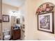 Nicely decorated half bath features stylish fixtures, mirror, and artful wall decorations at 290 Thomas Dr, Casselberry, FL 32707
