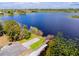 Aerial shot of a lake access with lush greenery, boat launch and pier at 290 Thomas Dr, Casselberry, FL 32707